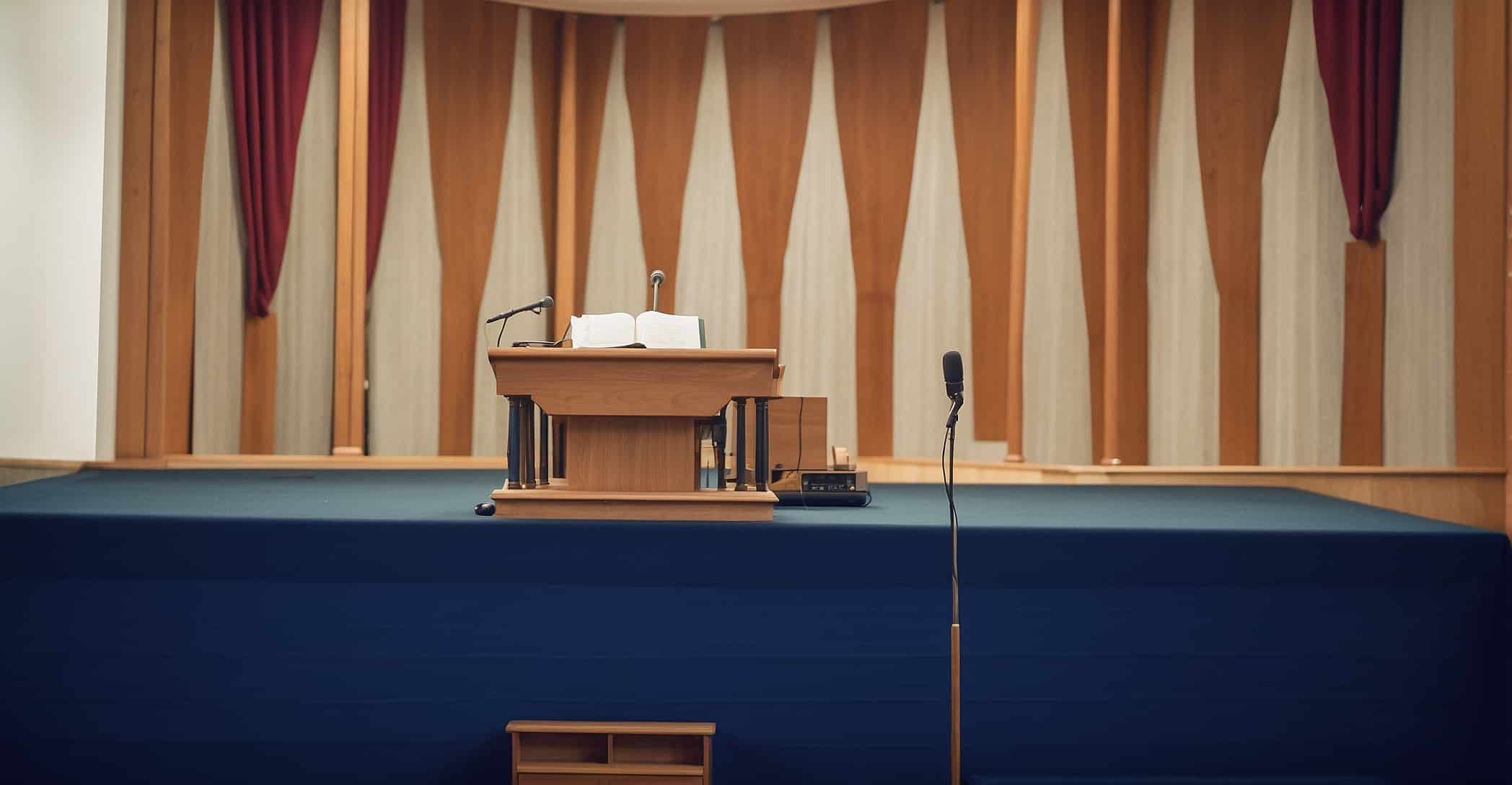 A church Altar with a pulpit, microphones and speaker